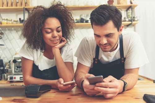 Restaurant employees looking at their schedules on mobile apps