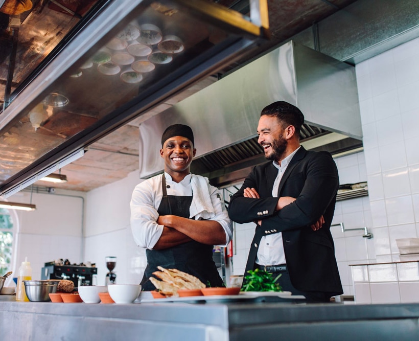 Chef and manager in kitchen