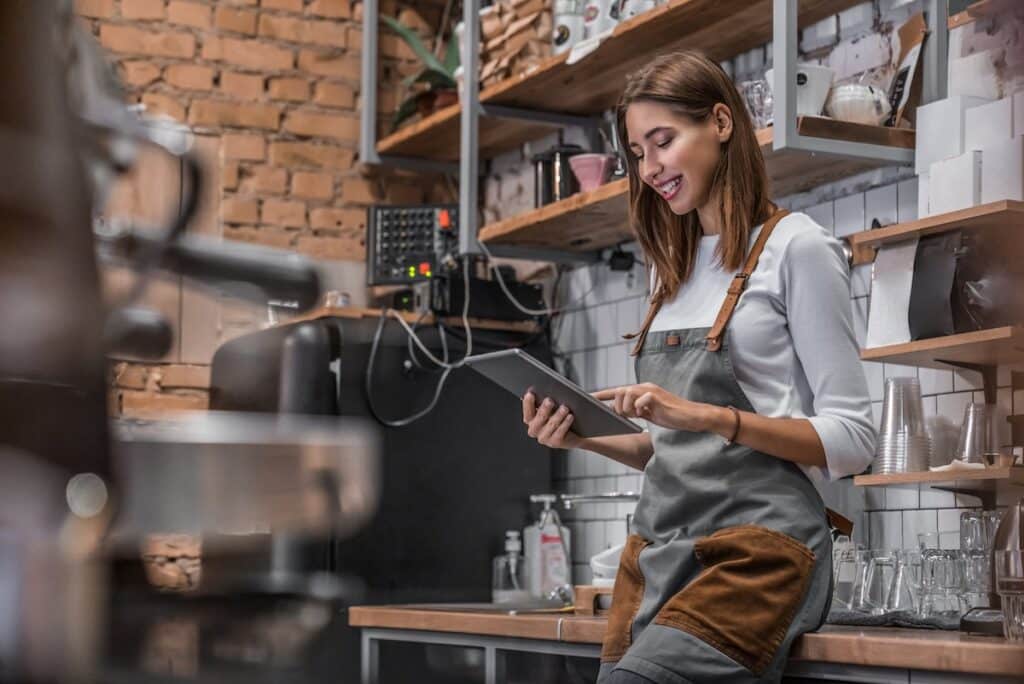 Barista filling out inventory management on a tablet device